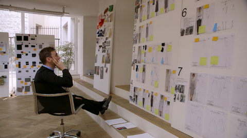 Designer Raf Simons contemplates his collection boards. Credit: CIM Productions